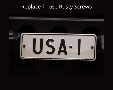 Rusty screws on a car license plate highlighting the need for Four Pack Stainless Steel License Plate Screws With Slotted Hex Heads.
