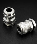 Half Inch NPT Brass Cable Gland Metal Cord Grip Strain Relief Two Pack Wire Protection, nickel-plated brass on black background