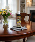 Top Shelf Wood Polish And Gloss Restorer To Wipe Away Scratches Haze And Dust For A Slick New Finish On Antique Cabinets And Wooden Dining Tables Without Breaking A Sweat on a polished wooden table.
