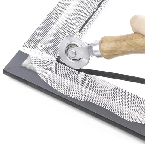 Screen Roller Tool With Bearing For Window Mesh Repair And Replacement in use on aluminum frame, beech wood handle visible.