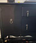 Front view of a dresser with Antique Bronze Lion Head Ring Pull Cabinet Handle, emphasizing its decorative design.