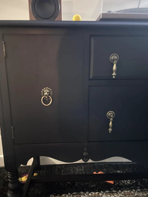 Front view of a dresser with Antique Bronze Lion Head Ring Pull Cabinet Handle, emphasizing its decorative design.