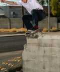 Skateboarder performing trick on street with California Roll 60mm 78A White Skateboard Longboard Wheels, built for park ramps and street cruisin