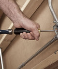 Person using Beefy Heavy Duty Demolition Screwdriver With Keystone Tip And Four Inch Shank for prying metal fixture