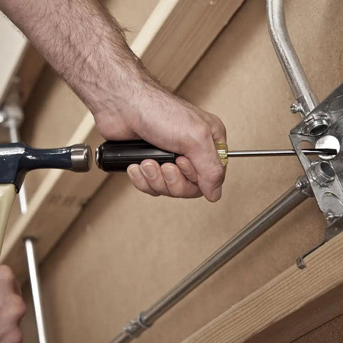Person using Beefy Heavy Duty Demolition Screwdriver With Keystone Tip And Four Inch Shank for prying metal fixture