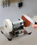 No Nonsense Mini Bench Grinder Rockin A Beefy 96W Copper Motor used for sharpening a knife with adjustable speed settings.