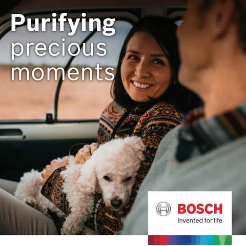 Woman smiling with her dog in a car, representing a fresh interior with Premium HEPA Cabin Air Filter For Lexus ES NX RX Series And Toyota Avalon Camry Top Rated For Cleaner Fresher Interior Air In Daily Rides That Smells Like New.