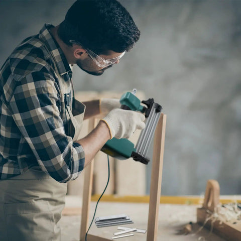 Man using Heavy Duty 1400 Piece 18 Gauge Brad Nails Kit For Pneumatic And Electric Nailers With Seven Flexible Lengths For Woodworking and Trim Work.