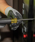 Person using Grab And Go Multi Bit Tamperproof Screwdriver Kit with Twenty Six Onboard Bits and Quarter Inch Nut Driver in elevator panel.