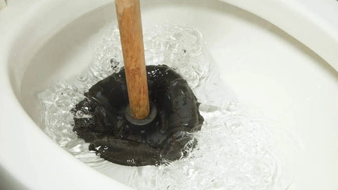 Heavy Duty Rubber Toilet Plunger With Solid Wooden Handle For Bathroom Sink Drains And Tub Clogs in toilet water.