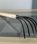 15 Inch Garden Rake With 5 Prong Steel Head And Solid Wood Handle For Gardening Beach Combing And Soil Loosening Comfortable Grip And Reinforced Rivet Construction Heavy Duty Outdoor Tool For Yard Work shown on a reflective surface