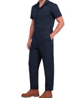 Heavy Duty Short Sleeve Coveralls For Men Work Jumpsuit Navy Cotton Polyester Blend Featuring Massive Storage Pockets Built Like A Rock Solid Workhorse For The Daily Grind on model with brown boots.