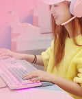 Close-up of a user with a Dope Pink Mechanical Gaming Keyboard And Mouse Combo With Full Spectrum RGB Backlighting, using a wireless headset.
