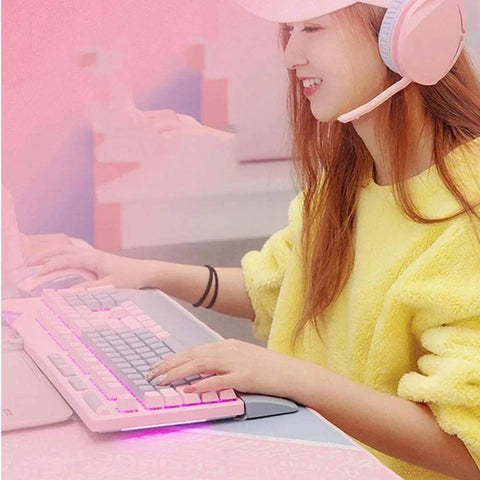 Close-up of a user with a Dope Pink Mechanical Gaming Keyboard And Mouse Combo With Full Spectrum RGB Backlighting, using a wireless headset.