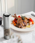 Electric Pepper Grinder Stainless Steel Rechargeable With External Coarseness Dial 95ml Capacity Silver Finish on dining table
