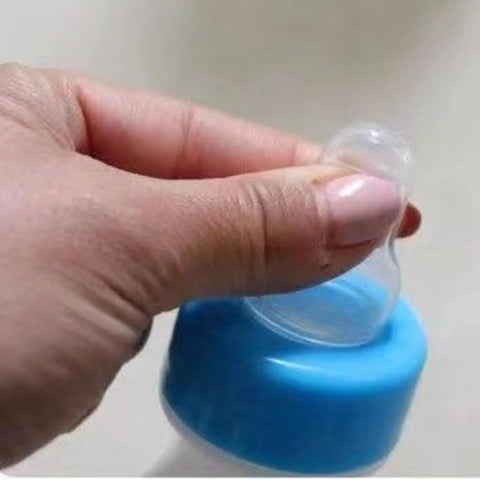 Close-up of hand holding Heavy Duty Lamb Feeding Bottle With Super Soft Nipple For Chill Weaning showing soft nipple.