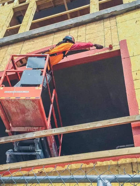 Construction worker applying FastFlash Fluid Applied Flashing Membrane For Windows Waterproof And Airtight Pro Grade Sealant