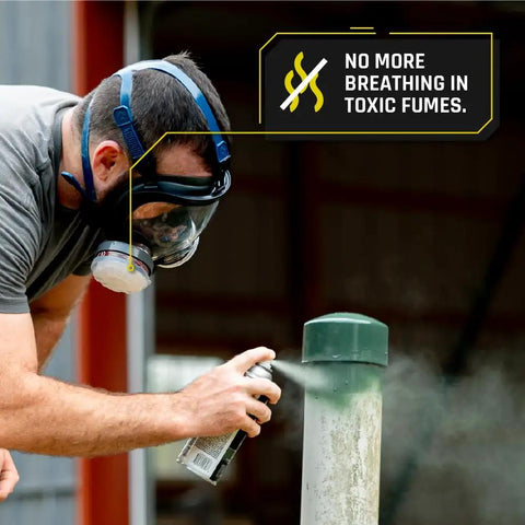 Person wearing Workhorse Full Face Respirator Mask for Work and Survival, using spray paint outdoors, highlighted anti-fog lens.