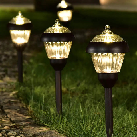 4 Pack High Lumen Metal Solar Pathway Lights with 2 Bright LED Per Light illuminating garden path at night