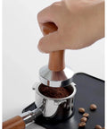 Hand using Stainless Steel Espresso Tamper With Pressure Regulator For 51mm 54mm 58mm Portafilters Flat Base Ground Coffee Press Tool