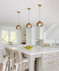 Gradient Gold Glass Pendant Light For Kitchen Island over white island in bright kitchen, modern vintage hanging lamp style