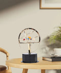 Gold Tone Solar System Model Decoration With Iron And Plastic Grand Orrery on a wooden desk with plants and a cup