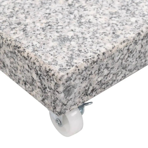 Close-up of corner granite and stainless steel tube parasol base with wheels for easy mobility and quick positioning, weather resistant.