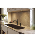 Braemore Mediterranean Bronze High Arc Kitchen Faucet With Side Spray in modern kitchen with stone countertop and backsplash