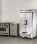 No Nonsense 40 Inch Reach In Freezer With 35 Cubic Feet Upright Cold Storage Tough Stainless Steel Cabinet Two Self Sealing Swing Doors 115V Plug And Play Kitchen Workhorse Rig in a commercial kitchen.