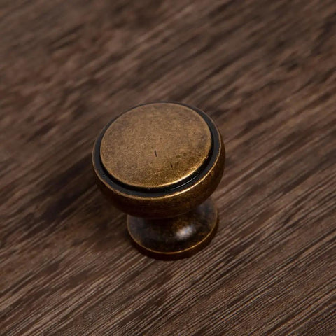 Round Knobs 1 Inch Solid Zinc Alloy Antique Brass Cabinet Handles, 4 Pack, Vintage Kitchen Bath Drawer Pulls on wood surface