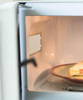 Microwave interior with installed 10 Pack Microwave Mica Insulation Sheets Heat Resistant Crisper Covers for protection and cleanliness.