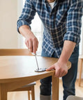 Person installing Solid Heavy Duty Butler Tray Hinges For Roll Top Desks And Drop Leaf Tables Dark Bronze on a wooden table.