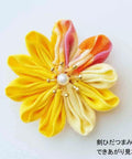 Yellow and orange fabric flower from Dope Tsumami Craft Plate Kit With Round Folding Knobs And Sword Horn Knobs Unisex DIY Plate Set.