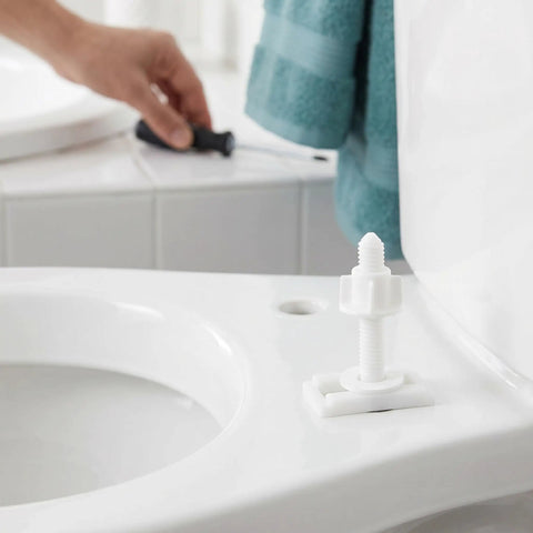 Close-up of toilet seat with 10 Piece Toilet Seat Bolt Kit With Plastic Screws Nuts And Washers, easy install