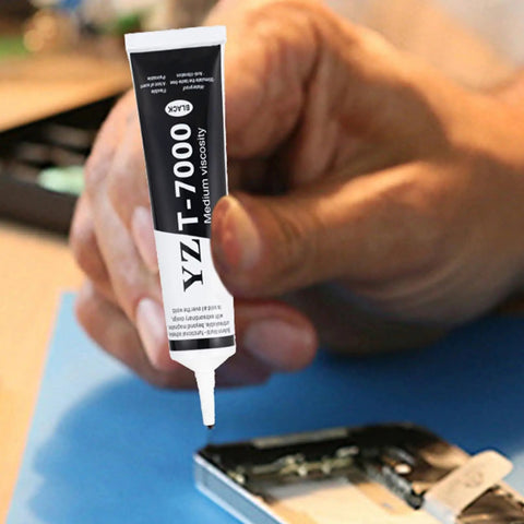 Person using Ultra Strong T7000 Phone Repair Glue For Screen And Frame Repair Multipurpose Adhesive For Cell Phones Back Covers And LCD Cracks Sticks Like Crazy For Durable Repairs Without The Hassle.