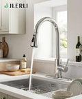 Jlerli Pull-Down Kitchen Faucet, High Arc, Brushed Nickel, 3-Modes Sprayer with water pouring into a sink.