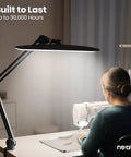 Mega Bright 2200 Lumens LED Desk Lamp With 24W Power Shadow Free Task Lighting illuminating a sewing workstation in black.