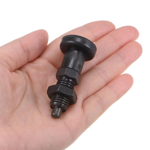 Heavy Duty Carbon Steel M12 Spring Plunger with ball nose tip and nuts, held in hand for secure clamping tasks.
