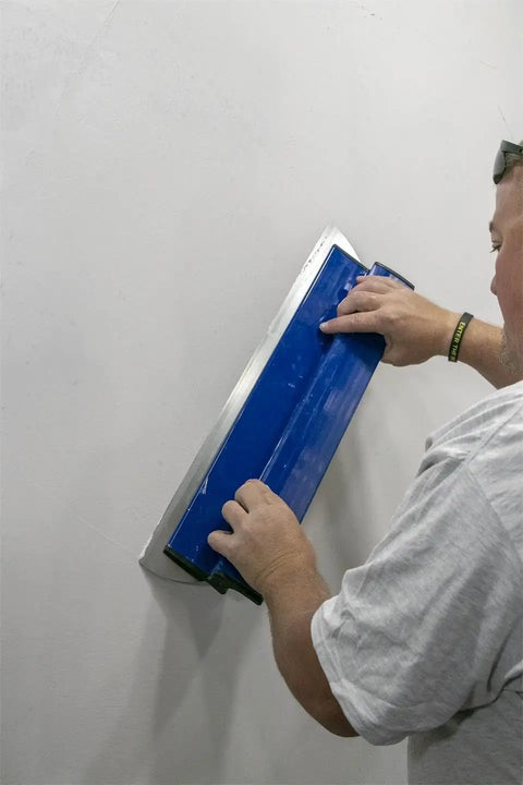 Person using ProSkim 24 Inch Drywall Tool For Ultra Smooth Finish Lightweight Skimming Blade Set Ergonomic Non Slip Handle Perfect For Plaster And Drywall Finishing Made In USA SKIM60 on wall.