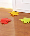 Leaf Shape Door Stopper 4 Pack with Sturdy PP Wedges Anti Skid Bottom Finger Protector To Prevent Injuries From Door Slams Durable Door Wedges For Home Office And Hotel placed on wooden floor