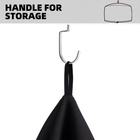 Close-up of a black Waterproof Pizza Oven Cover for Arc and Tread Models with a handle for storage on a hook, fabric visible.