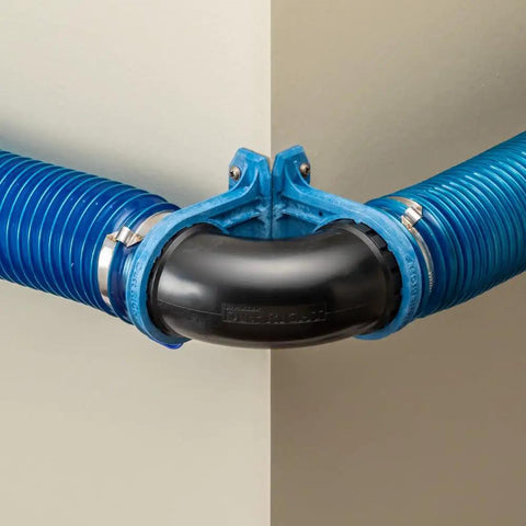 Side view of Ready Mount Two And A Half Inch 90 Degree Elbow Dust Collection Connector For Two Hoses Durable ABS Construction Easy To Install No Fuss Secure Fit Angled Woodworking Dust System For Flexible Positioning In Any Angle in use with blue hoses.