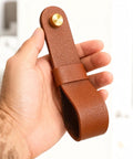 Six Piece Robust Leather Curtain Rod Holders With Universal Wall Mount Kits For Towel Bars And Fresh Home Decor Looks Featuring Zero Hassle Screws That Actually Deliver Top Shelf Quality, showing brown leather holder in hand.
