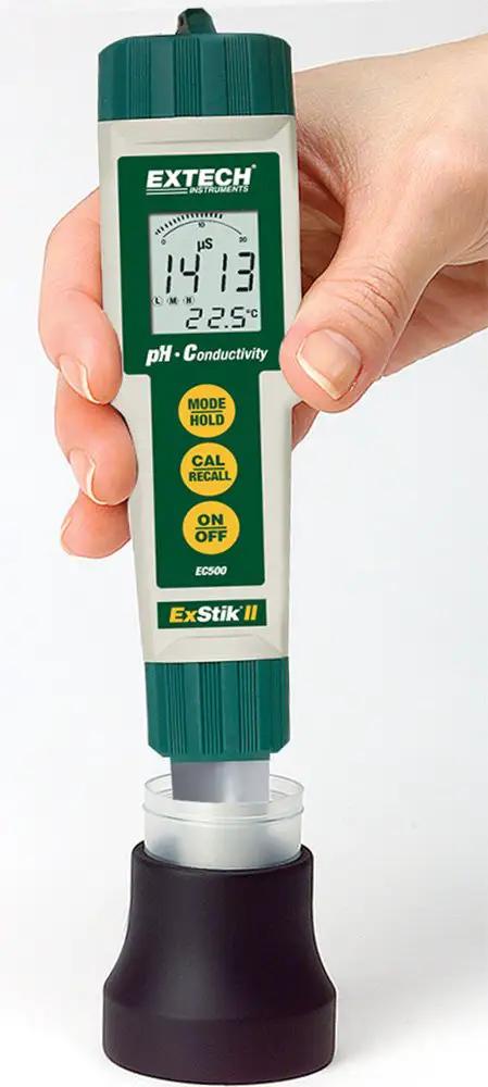 Person holding Waterproof ExStik II pH and Conductivity Meter with display, all-in-one electrode showing µS/cm and Celsius readings