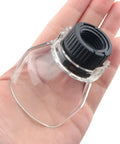 Close-up of a transparent rotating tool guard in a hand, part of a 2 Pack Transparent Rotating Tool Guard Safety Dust Cover Set For Metal Cutting, Wood Sanding, And Polishing Debris Splash Shield Compatible With Angle Grinders And Engraving Machines.