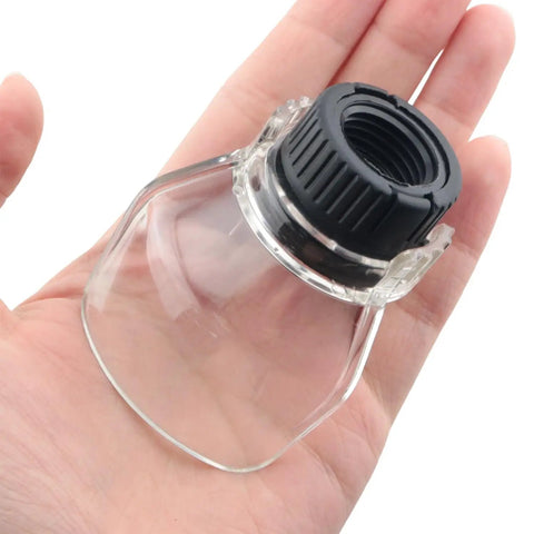 Close-up of a transparent rotating tool guard in a hand, part of a 2 Pack Transparent Rotating Tool Guard Safety Dust Cover Set For Metal Cutting, Wood Sanding, And Polishing Debris Splash Shield Compatible With Angle Grinders And Engraving Machines.