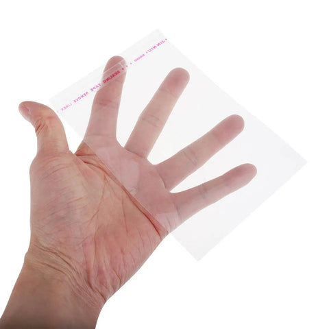Hand holding a clear resealable cookie bag 10x15cm self sealing snack bag OPP pouch for bakery treats quick packaging.