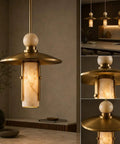 Modern Brass Pendant Chandelier Light Fixture with Alabaster Cylinder Shade Luxury Natural Stone Hanging Ceiling Light with Spherical Marble Accent for Kitchen Dining Room, Bar & Living Room Set of 3 in stylish kitchen setting.