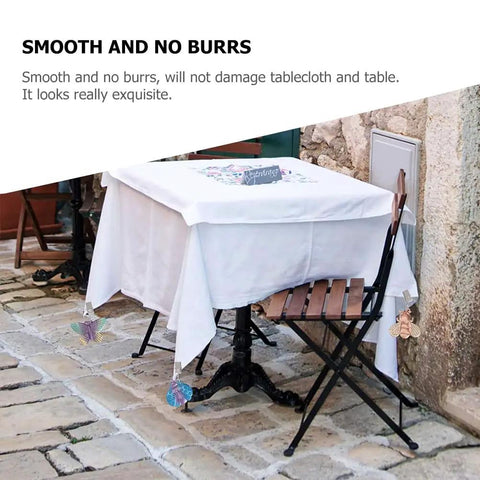 Alloy Tablecloth Clips Eight Pack 2.36 Inch Wide Non Slip Outdoor Tablecloth Holders on patio table with butterfly charms