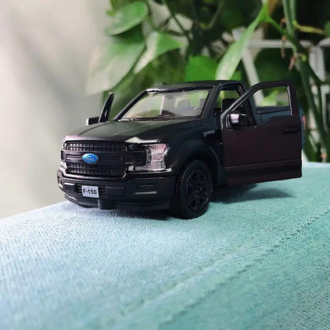 Licensed F150 One Thirty Six Scale Zinc Alloy Die Cast Pickup Truck Toy For Kids Toddlers with doors open on a blue surface